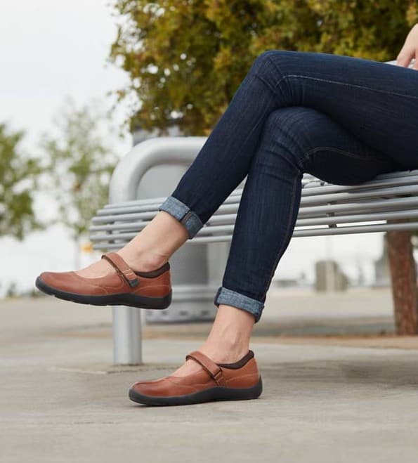 Patient discussing diabetic shoe coverage with pharmacy staff.